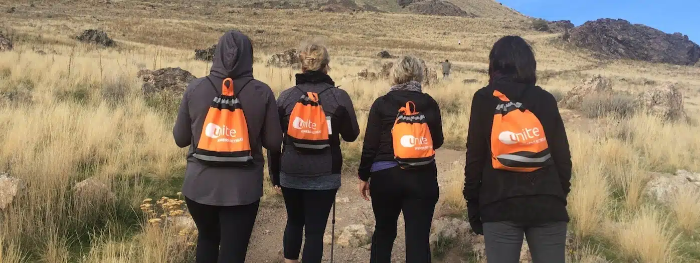 ladies hiking at unite fitness retreat